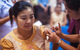 A photo of a woman receiving a vaccine.