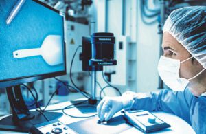 A Freudenberg Medical employee inspects a precision injection molded medical component at the company's Kaiserslautern operation in Germany