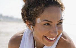 A woman with a wearable medical device stuck to her head