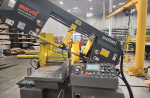 A horizontal mitering bar saw in a workshop