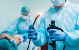 A gastroenterologist holding an endoscope.