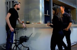 Spinal cord injury patient Gert-Jan Oksam standing at a bar for drinks with friends while wearing experimental "digital bridge" technology to send leg control signals from his brain to his spine.