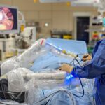 A surgeon using the Moon Surgical Maestro surgical robotics system.