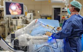 A surgeon using the Moon Surgical Maestro surgical robotics system.