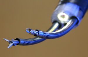 A photo of an endoscopic robot's curved arms with instruments at the end.