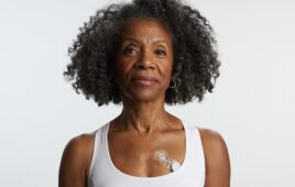 A photo of a woman wearing iRhythm's next-generation Zio cardiac monitoring patch.