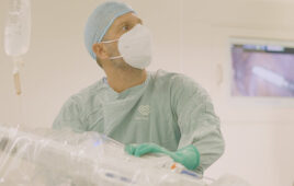 A photo of Dr. Salomón Zebede preparing to operate using Medtronic's Hugo robotic-assisted surgery system at Pacifica Salud Hospital in Panama.