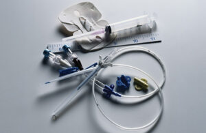 A photo of catheters, syringes and other medical devices with tubing.
