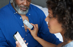 A physician uses an Eko Health Duo digital stethoscope to collect acoustic and ECG data from a patient.