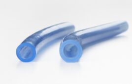 A side-by-side view of a pair of medical tubes showing one that's enlarged due to the use of engineered silicone swelling fluids.