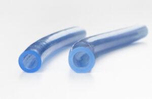 A side-by-side view of a pair of medical tubes showing one that's enlarged due to the use of engineered silicone swelling fluids.