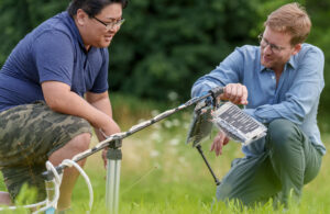 A photo of Max Planck ETH Center for Learning Systems researchers Thomas Buchner (right) and Toshihiko Fukushima with their robotic leg system.