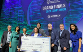 A photo of Samay CEO and founder Dr. Maria Artunduaga holding a check for the 2024 MedTech Innovator grand prize.