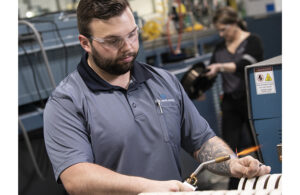 A photo of a Fort Wayne Metals employee heating nitinol, a nickel-titanium alloy used for medical devices and components.