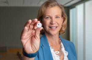 A photo of Abbott Medical Devices President Lisa Earnhardt with a FreeStyle Libre 3 sensor — used in one of the top Medical Design & Outsourcing stories of 2024.