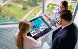 This is a Mayo Clinic marketing image showing people interacting with Mayo Clinic Digital Pathology on a big computer display.