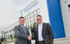 This Freudenberg Medical marketing image shows CEO Michael McGee on the left shaking hands with outgoing CEO Mark Ostwald in front of a company facility.