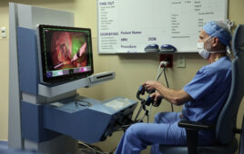 A photo of Dr. Steve Rothenberg at the controls of the Asensus Surgical Senhance system.