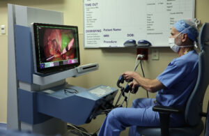 A photo of Dr. Steve Rothenberg at the controls of the Asensus Surgical Senhance system.