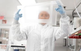 A Lubrizol specialty silicone employee holding up a medical-grade silicone sheet.