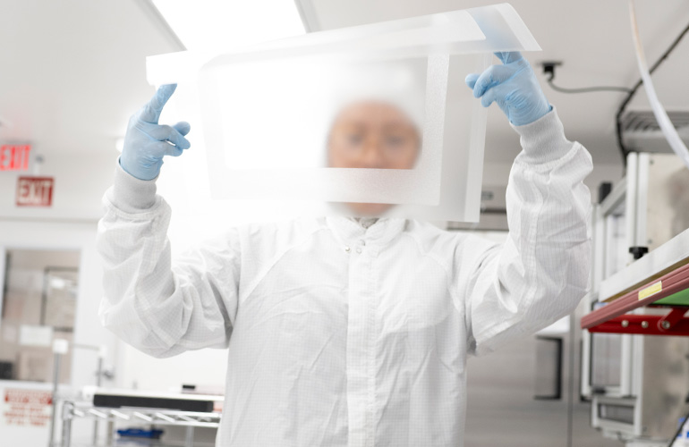 A Lubrizol specialty silicone employee holding up a medical-grade silicone sheet.
