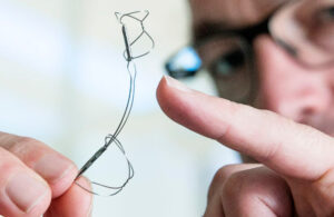 A photo of the Cardiac Dimensions Carillon Mitral Contour System in a physician's hand.