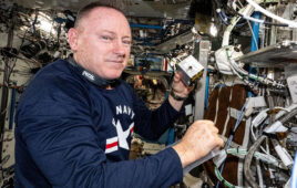 A photo of NASA astronaut Butch Wilmore holding an Auxilium bioprinter aboard the International Space Station.