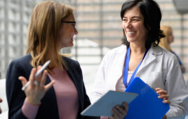 A photo of a medical device design expert speaking with a doctor.