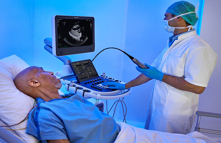 A photo of an ultrasound exam using a Philips Epiq system with AI features.