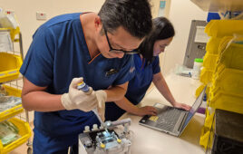 A photo showing Assistant Professor Yeo Kee Thai and KKH Dr. Genevieve Llanora showing the BLIPI device for newborn blood testing.