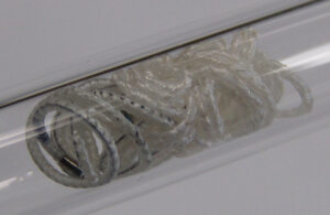 A photo of the Embolization Inc. Nitinol Enhanced Device (NED) deployed inside a glass tube. 