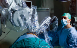 A photo of a physician with a surgical robotics system.