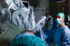 A photo of a physician with a surgical robotics system.
