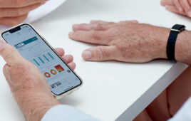 A photo of the Aktiia G0 Blood Pressure Monitoring System and app.