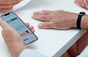 A photo of the Aktiia G0 Blood Pressure Monitoring System and app.