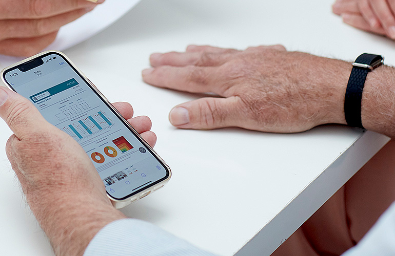 A photo of the Aktiia G0 Blood Pressure Monitoring System and app.