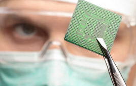 A photo of someone inspecting a microchip.
