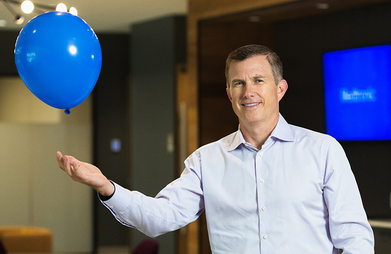 A photo of Medtronic CEO Geoff Martha with a blue balloon.