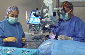 A photo showing an eye surgeon using BVI's R-Evo Smart phaco machine in an operating room.