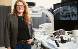 A photo of Capstan Medical CEO Maggie Nixon posing with the structural heart startup's robotic catheter delivery system.