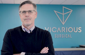 An image of Vicarious Surgical CEO Stephen From in front of the company logo.