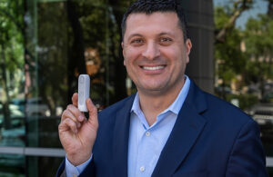 A photo of Ali Dianaty holding MiniMed Flex.