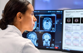 A photo of a clinician viewing Cortechs.ai neuroimaging analytics resulting from a scan on a Philips MR system.