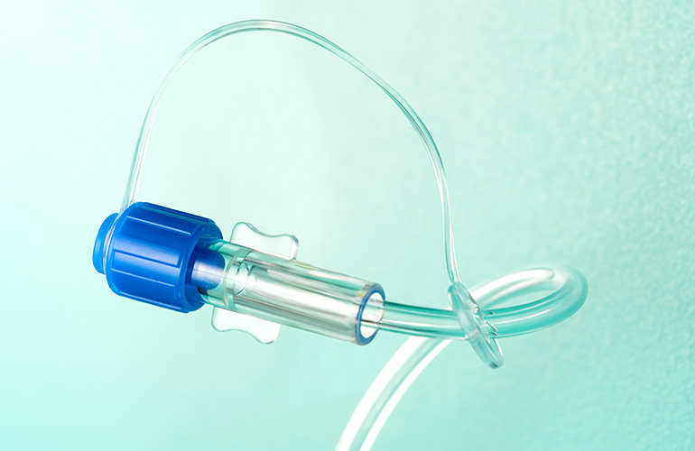 A photo of a female Luer lock connector with tubing port.