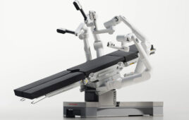 A photo of Johnson & Johnson MedTech's Ottava surgical robotics system table with arms deployed.