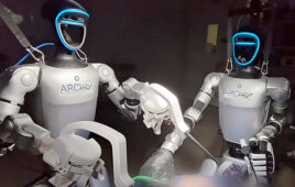 A photo of two humanoid robots performing a surgery.